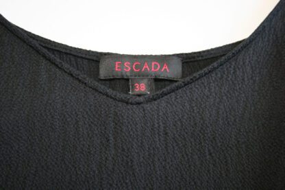 Closeup view of the Escada label and size tag in a black silk camisole