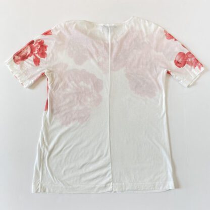 A full rear view of a J.Crew tee whosing the flower print continuing on the back of the sleeves.