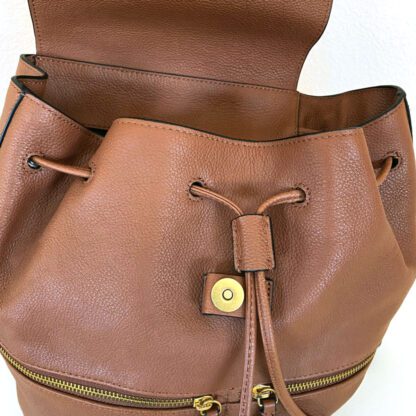 Front view of a Banana Republic leather backpack showing the drawstring closure and front zippered pockets