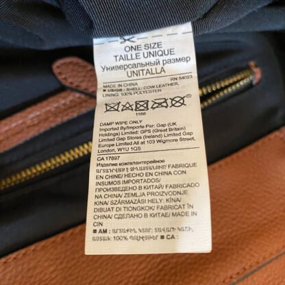 Closeup of preloved Banana Republic leather backpack material tag