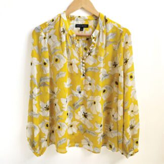 Front view of a Banana republic floral blouse in yellow with black and white flowers