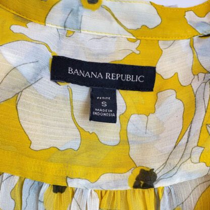 Closeup of yellow floral blouse with view of the Banana Republic brand label and size tag