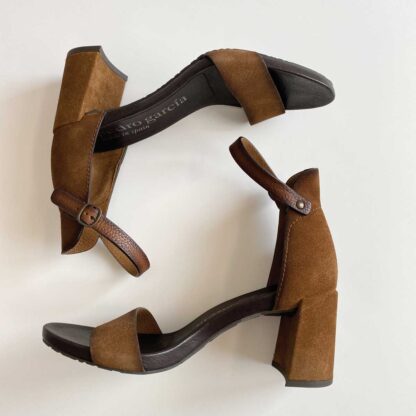Overhead view of Pedro Garcia strappy heels in profile, with the right shoe above the left shoe.