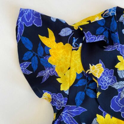Sleeve detail of preloved Banana Republic floral wrap blouse in a blue, yellow and pink print