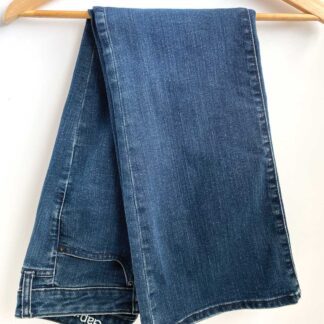 A pair of vintage Gap women's jeans in the Long and Lean fit, folded in half and folded over a wooden hangar.