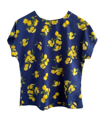 Full front view of a Banana Republic short-sleeved blouse with a dark blue background and a lemon print.