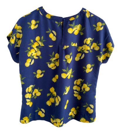 Full rear view of a Banana Republic short-sleeve blouse with a dark blue background and a lemon print.