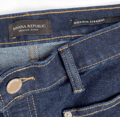 a detail photo showing the waist band and the inside product tags of a pair of Banana Republic cropped denim pants in dark wash