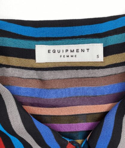 close-up view of the neckline and product tag of an Equipment striped silk blouse