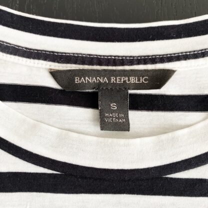 close up view of the Banana Republic label and size tag in a black and cream stripe tee